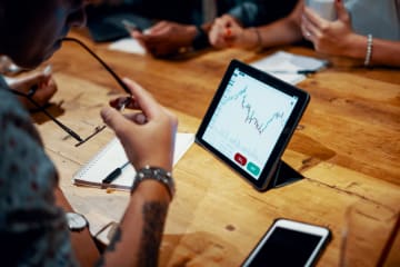 Man studies chart presented on his Ipad