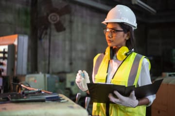 Female mechatronics engineer operates a machine