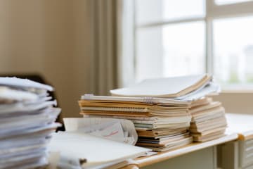 A cluttered desk with notebooks