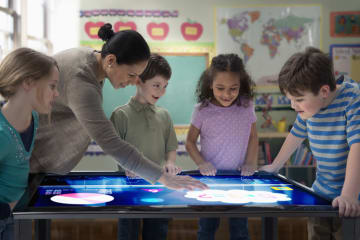 Diverse students interacting with an electronic map