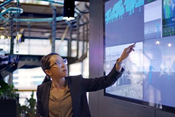 Female Operations research specialist giving presentation in office