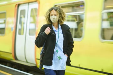 Travel nurse in front of subway