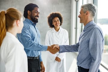 Healthcare administrators shaking hands 