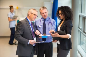 healthcare administrators having a conversation in a hallway