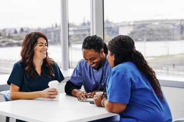 Nurses laughing together at work