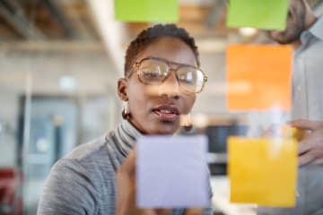 Creative director writing down notes about her ideas