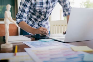 A designer working at his desk with a laptop