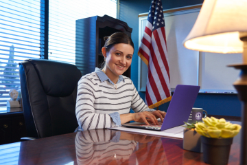 woman principle sits in office space