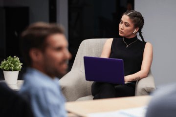 woman works at laptop with headphones in