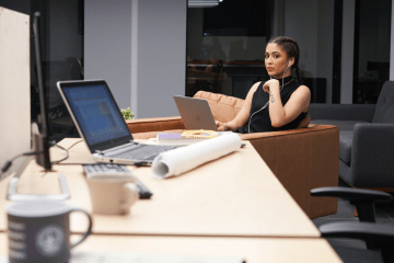 abandoned laptop alerts woman sitting close by