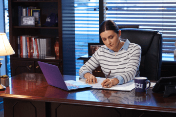 principal working in office space at desk