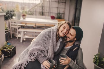 Couple sitting together on patio