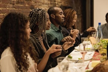 Family giving thanks to God together at the table