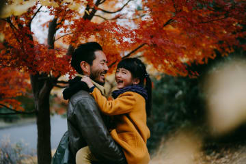 Father holding little girl in his arms