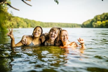 Friends swimming in lake