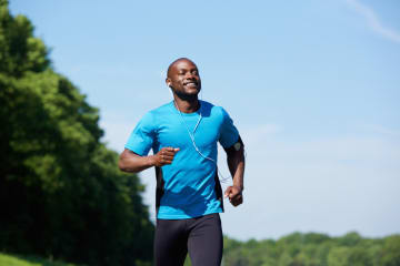 Happy man running in a park