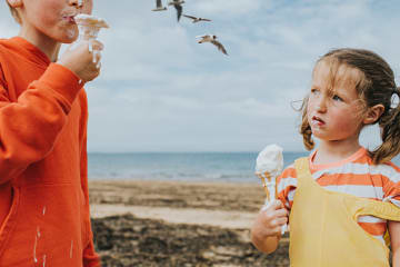 Little girl looking at big brother with resentment