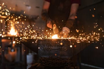 Man using his God given talents forging in his workshop