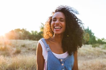 Woman enjoys a sunny day in an open field