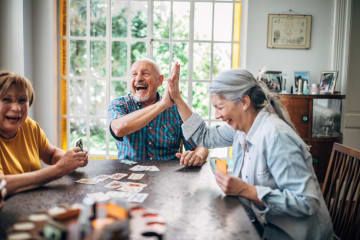 Friends encouraging each other during a card game