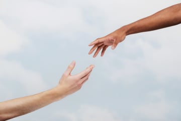 Two hands reaching out to help each other