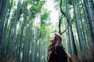 Woman taking in the beauty of God's creation in the forest 