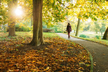 girl walking on path in a park