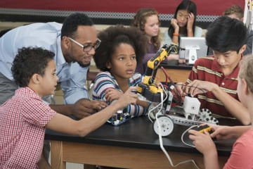 Black STEM educator teaching kids science