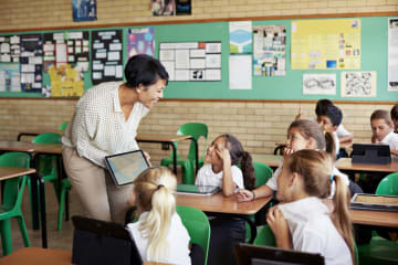 A teacher consulting with her students