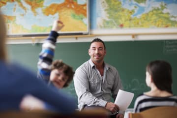 male teacher speaking to students