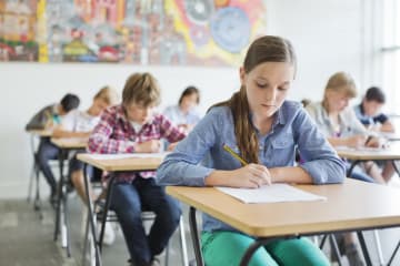 young students taking test in classroom