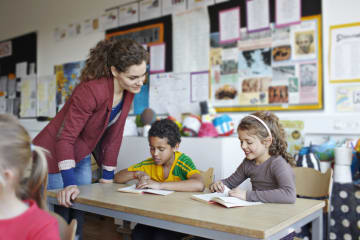 female teacher working with young students