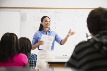 Female teacher speaking in front of class