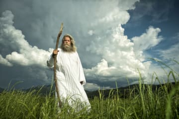 God walking in grass field 