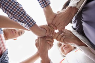 Group of hands clasped in prayer