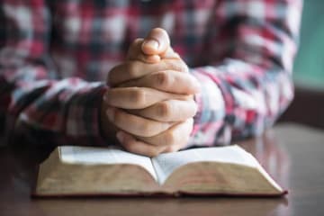 Man in plaid shirt meditates over a more excellent way passage in bible