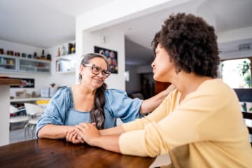 Mother consoling her daughter at home