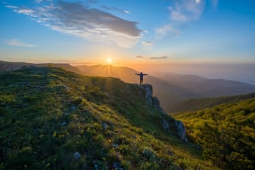 Person standing on top of mountain