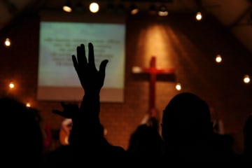 Worshipping in church with hand in the air