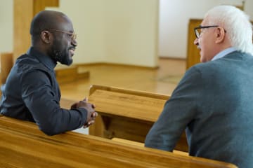 Pastor talking with a male member of the congregation