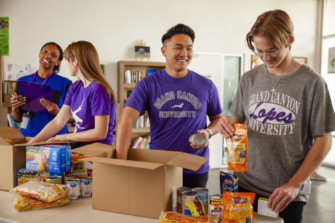 Male and female BSW majors volunteering to pack food