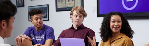 Business students gathered around a conference table