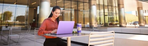 GCU student using a laptop outside