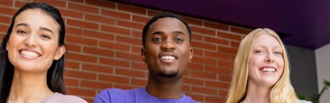 Male and female marketing minors smiling outside GCU's campus