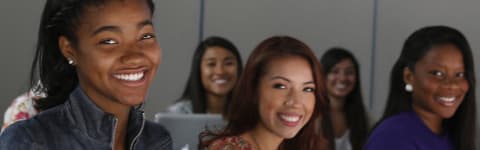 Evening degree students smiling in classroom at GCU