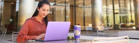 GCU student sitting outside working on laptop