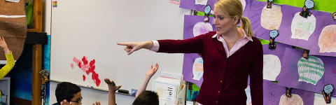 a teacher answering questions in class