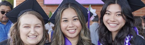 Students smiling and celebrating commencement