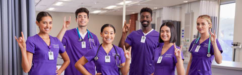 GCU Phoenix ABSN Students holding lopes up in a hospital 