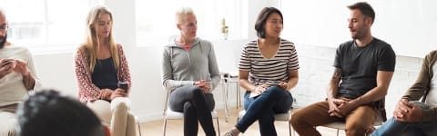 Group sitting in a circle for therapy session